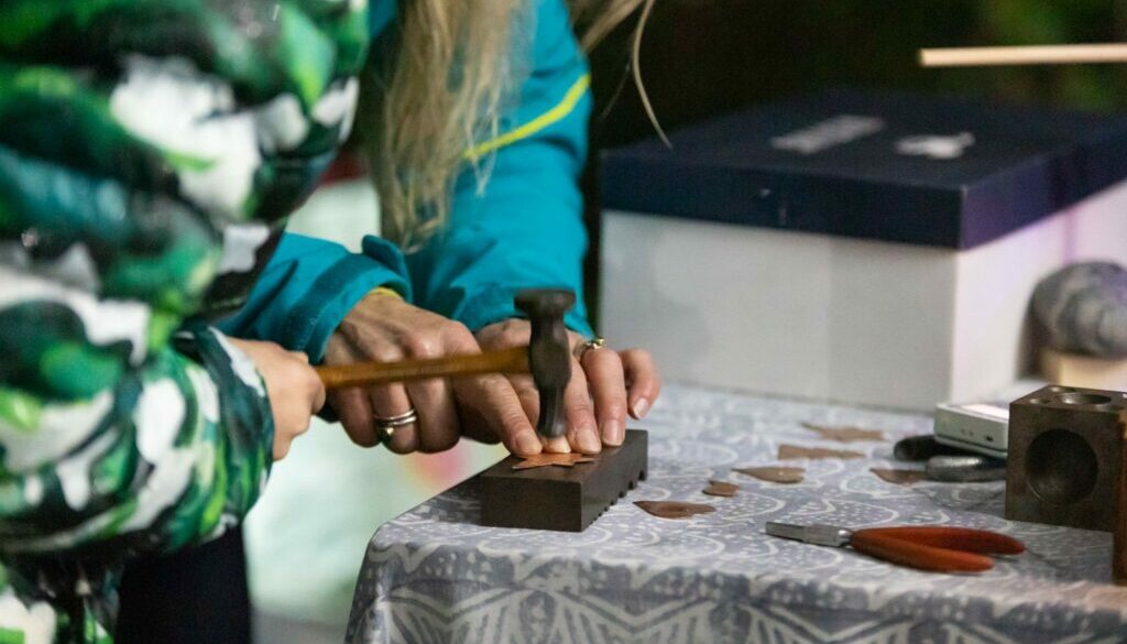 hammering a piece of metal for jewellery making