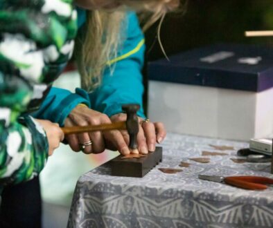 hammering a piece of metal for jewellery making